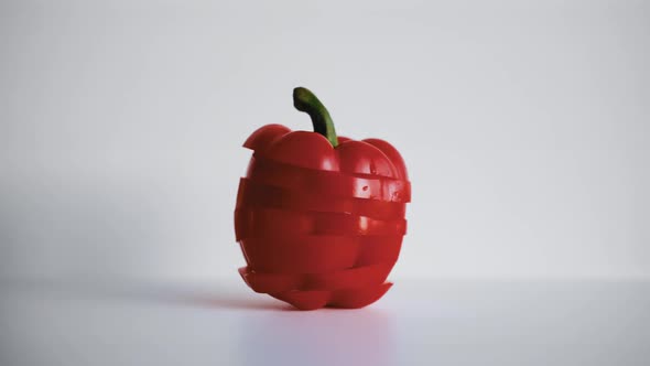 Slicing Red Pepper on a White Background