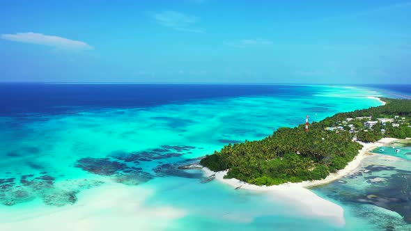 Luxury birds eye tourism shot of a sunshine white sandy paradise beach and aqua blue ocean backgroun