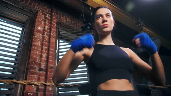 Angry Young Female Mma Fighter with Wrapped Hand Ready to Battle Without Rules Low Angle