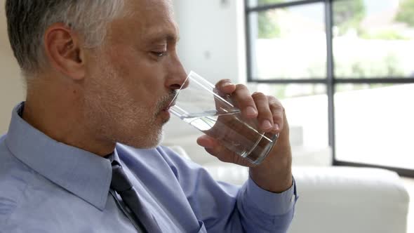 Man drinking water glass