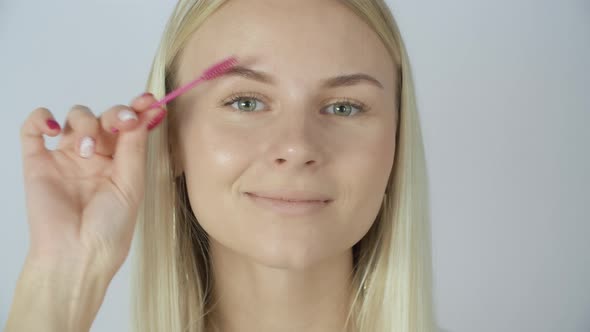 Woman Painting Eyebrows with Brush