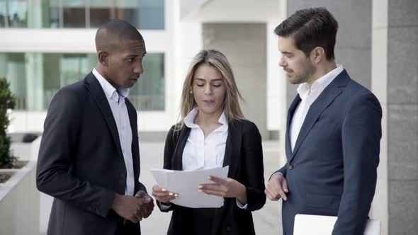 Business Colleagues Reviewing and Discussing Paper