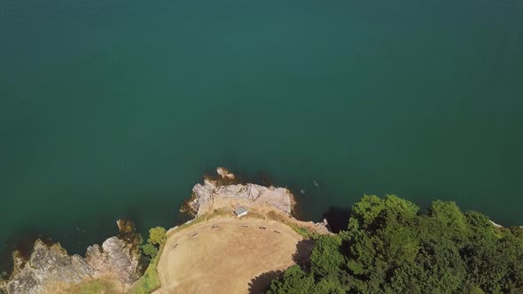 Overhead view of cliffs in coastal town in Brixham England. Cliff and woodland view from the sky.