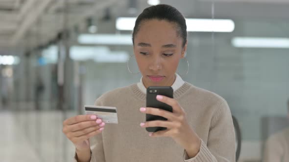 Creative African Female Making Successful Online Shopping Payment on Smartphone