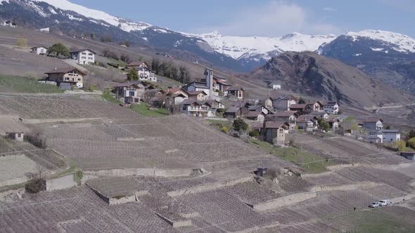 Aerial shot of small village in the vineyard called Signèse. Rhône valley, SwitzerlandSpring time,