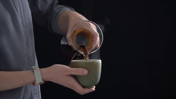 Woman pouring coffee into cup