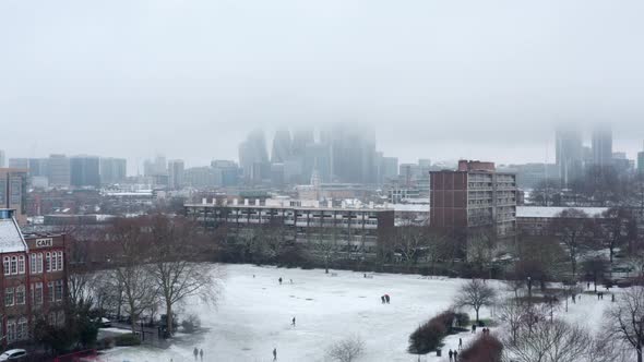 Rising aerial drone shot City of London snow day January