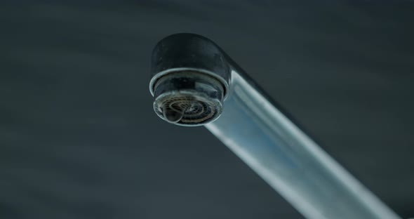 Water drops dripping from the tap.