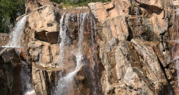 Waterfall over rock wall