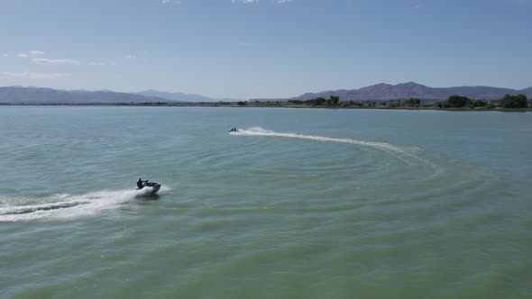 Pair of Two People Having Fun Riding Jet Ski Sea Doos on Utah Lake, Aerial