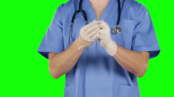 Man Take Off and Puts on His Surgical Gloves, Green Screen, Closeup