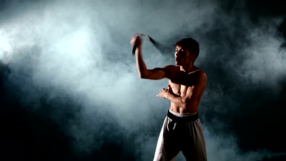 Man Practicing Karate or Kung Fu. Master Holding Nunchuck. Close Up