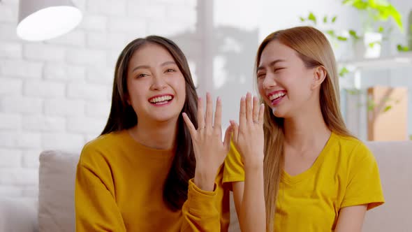 An Asian lesbian couple is wearing wedding rings
