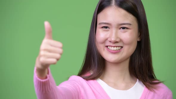 Young Beautiful Asian Woman Giving Thumbs Up