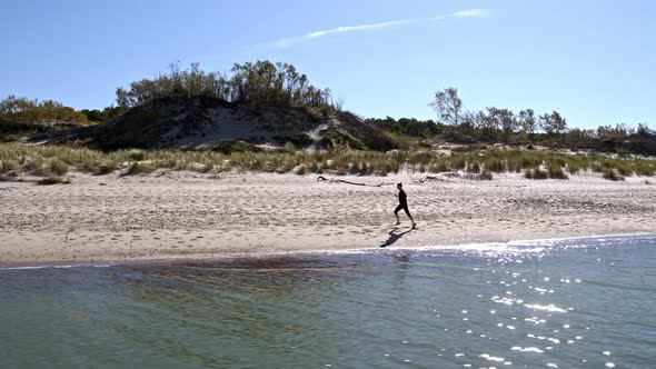 Beautiful Girl Runs Along the Bay