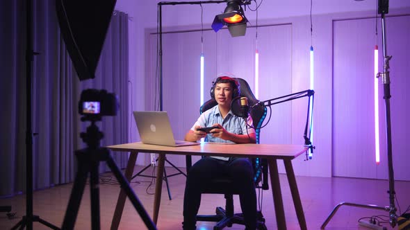 Asian Kid Boy Holding Phone And Talking To Camera While Live Stream, Professional Light Equipment