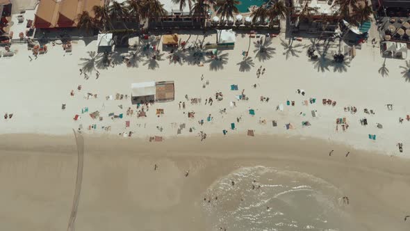 Aerial beach view people relaxing playing sunbathing on vacaion