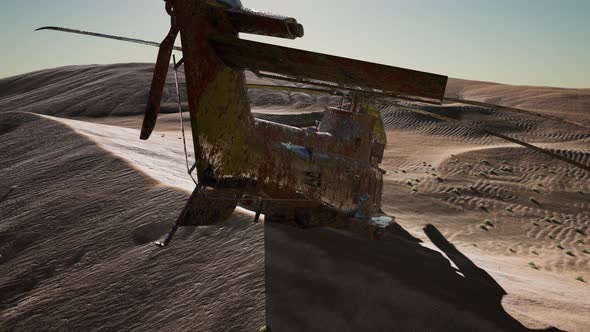 Old Rusted Military Helicopter in the Desert at Sunset alt