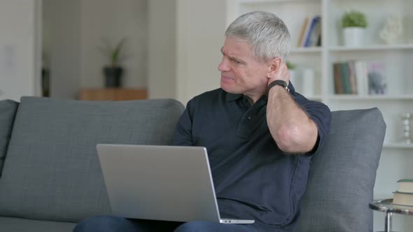 Tired Middle Aged Businessman Having Neck Pain on Sofa