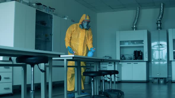 Person Cleans Tables in a Room with Sanitizer. Covid19, Coronavirus Concept.