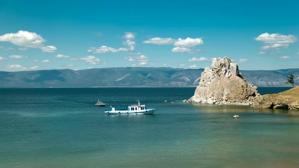 View of the Baikal Bay Shamanka in Summer Day. Ships and Tourists Swimming in Bay