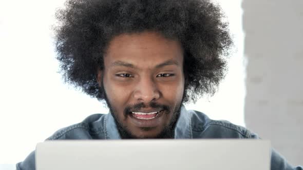 Close Up of Online Video Chat on Laptop at Work By African Man