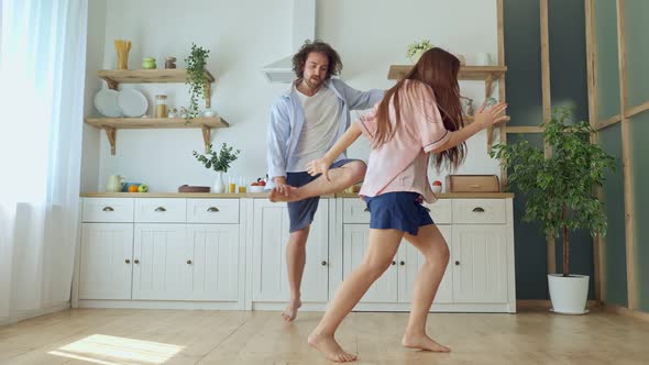 Lovely Couple Having a Fun Together While Dancing at the Bright Kitchen.