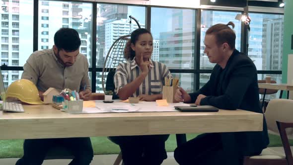 Creative Business People Group Having Conversation at Office Desk in Workplace