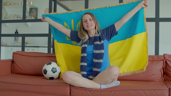 Lovely Female Football Fan Watching Match on Tv and Singing National Anthem