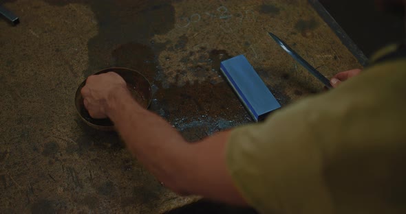 Artisan is Watering Japanese Waterstone and Sharpening Ancient Knife Closeup View  Prores