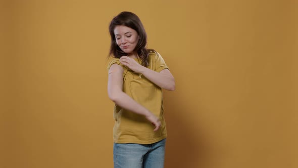 Portrait of Smiling Woman Lifting Sleeve and Showing Band Aid After Covid or Flu Vaccine Flexing Arm