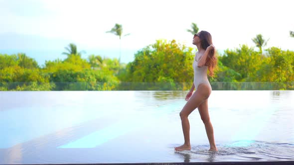 Young asian woman enjoy around outdoor swimming pool for leisure