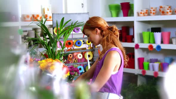 Female florist working in flower shop