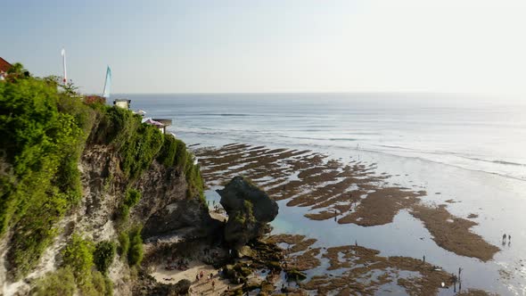 Drone Flight Over Cliffs And Seaweed On Bali Beach