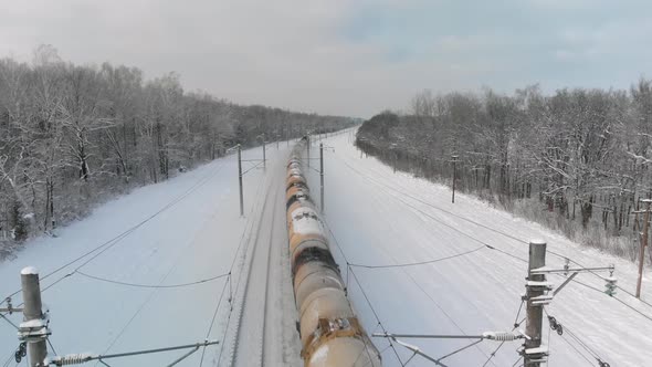 Railway Train with Tank Cars in Winter Countryside