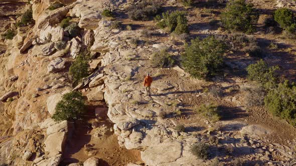 Aerial shot of a hiker at the the edge of Cedar Mesa in Utah