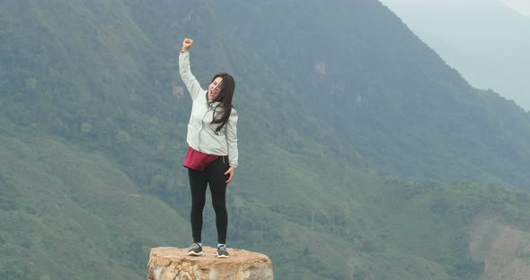 Asian Woman Happy On Top Of Mountain