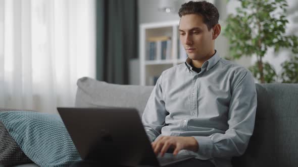 Man Using Laptop for Work at Home