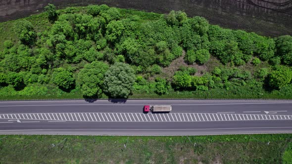 Aerial Road Cars Moving in the Green Fields of Summer