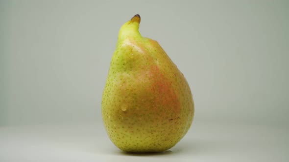 A Heart Shaped Green Pear Moving On A Turntable - Close Up Shot