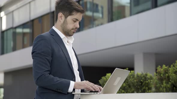 Serious Focused Businessman Working Outdoors