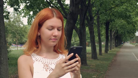 Ginger Student Using Smart Phone Outdoor
