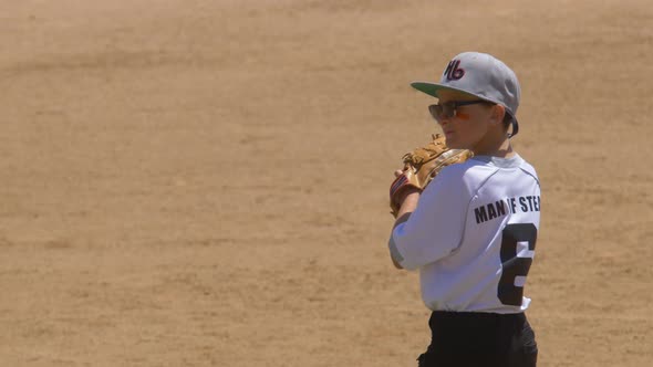 Boy plays pitcher in a little league baseball game.