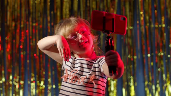 Cute Child Kid Blogger Recording Video Blog Vlog on Mobile Phone Making Selfie Photo in Night Club