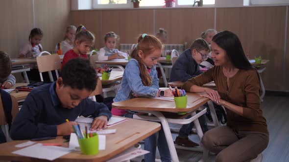 Female Teacher Communicating with Schoolgirl