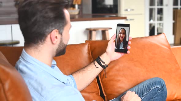 A Young Handsome Guy Using a Mobile Phone for Video Call