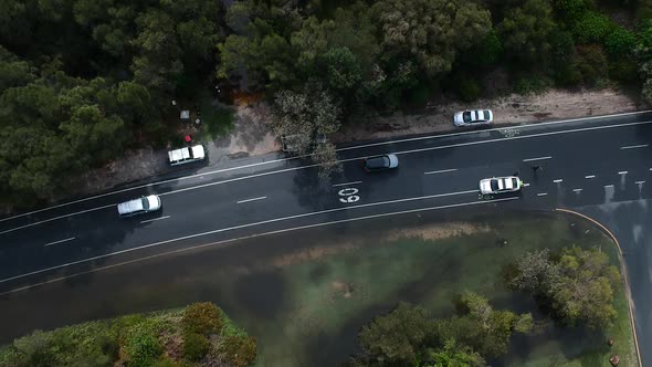 Aerial footage of police directing traffic away from a flooded roadway after a recent down pour on t