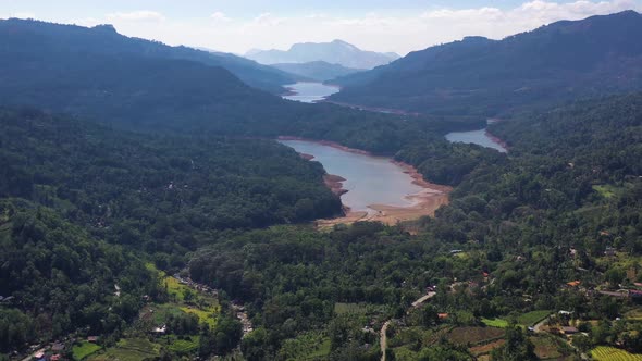 Aerial view of a river crossing the forest in Nuwara Eliya, Sri Lanka.