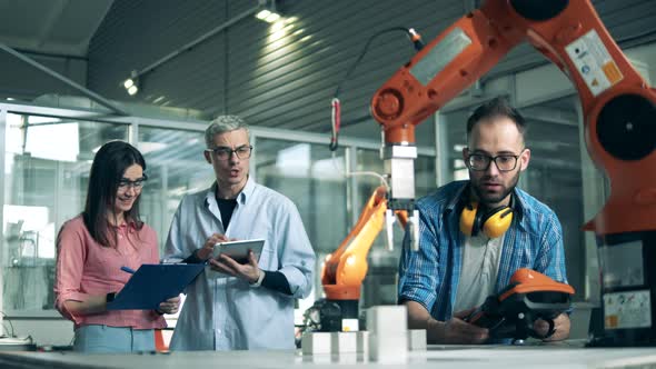 Modern Science Laboratory. Engineers Check Robotic Device at Science Laboratory.