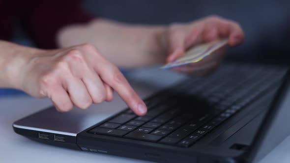 Female hands of cardholder holding credit card making e bank online payment